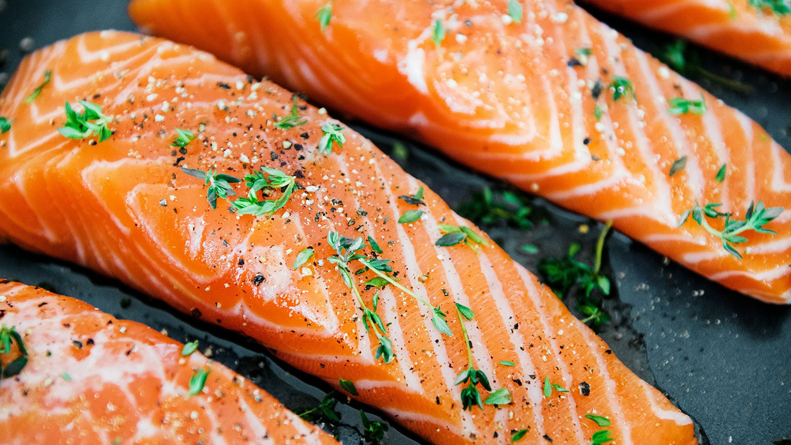 Fertility-supporting whole foods including salmon, walnuts, leafy greens, and berries